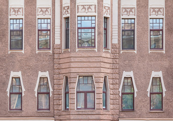 Obraz premium Several windows in a row and bay window on facade of urban apartment building front view, St. Petersburg, Russia.