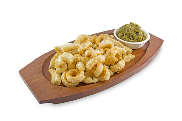Pork rind with wooden dish on white background