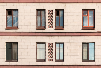 Fototapeta na wymiar Several windows in a row on facade of urban apartment building front view, St. Petersburg, Russia.