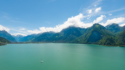 Fototapeta na wymiar Canton Uri. Grandiose panorama of the mountains and lake. Summer day in Alps. Europe.