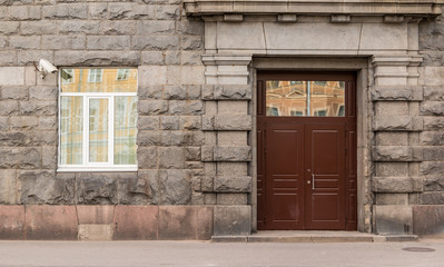 Window and door on facade of urban office building front view, St. Petersburg, Russia.