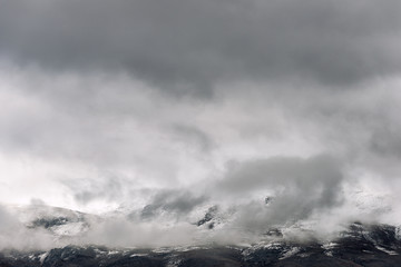 The low clouds over high mountains at winter day