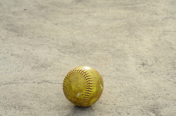 Fototapeta na wymiar old softball on cement