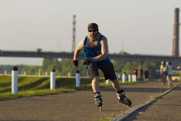 A man riding on roller skates in the city