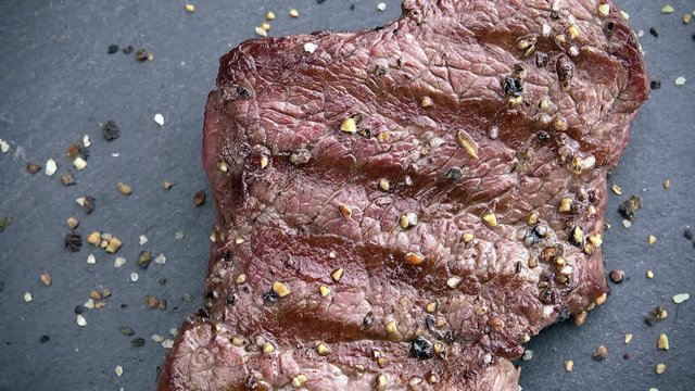 Grilled Beef as not loopable 4K UHD footage on a slate slab