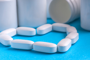 Many pills and tablets isolated on light blue background