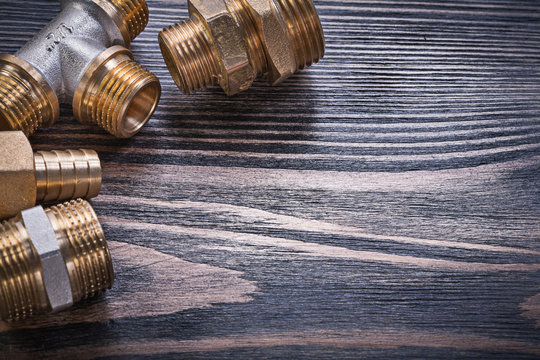 Composition Of Brass Connectors On Wooden Background Plumbing Co