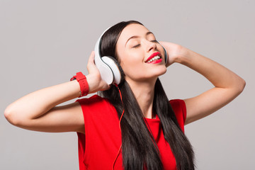 Fototapeta premium Joyful delighted woman listening to music