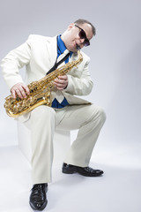 Fototapeta premium Music Concepts. Caucasian Mature Male Musician Playing Alto Saxo