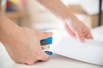 Obraz na płótnie Canvas using stapler