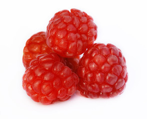 Three raspberries on a white background