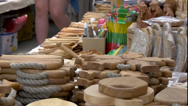 Lots of wooden decorations and stuffs in display from a souvenier shop where there are chopping boards pens and other stuff to choose from