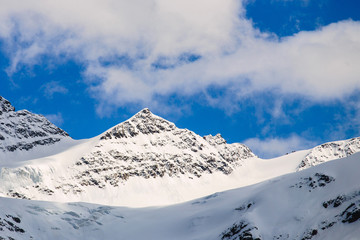 Fototapeta na wymiar Panorama of mountainsides covered by deep snow