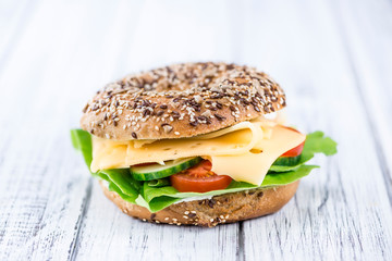 Wooden table with Cheese Bagel (selective focus)