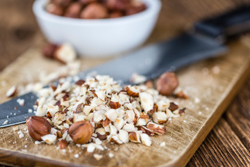 Wooden table with chopped Hazelnuts