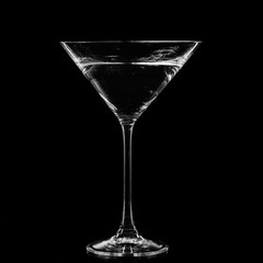 Martini in a cocktail glass isolated on black background
