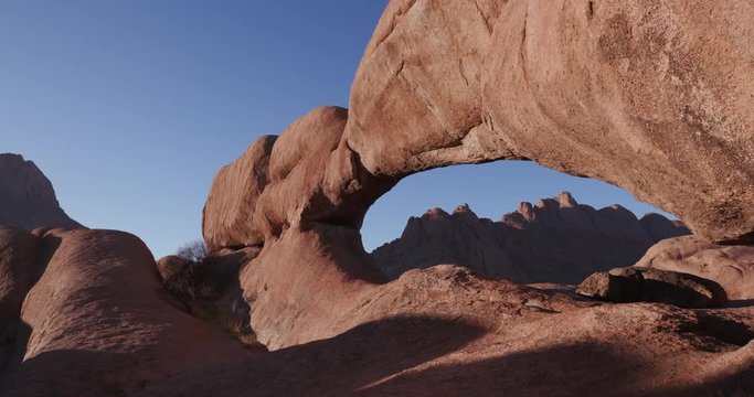 4K panning shot of the famous rock arch of the Spitzkoppe mountains