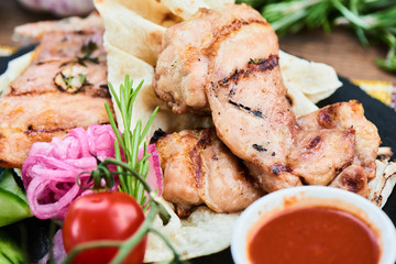 Fried bacon and zucchini with tzatziki sauce served on a stone Board closeup