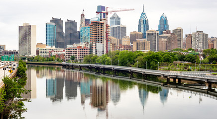 Fototapeta na wymiar Rain drops in a river with reflection of Philadelphia