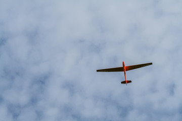 Red aeroplane gliding in the sky