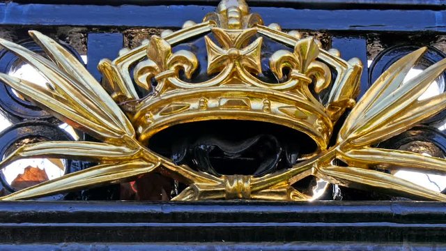 The golden crown on the fence in one building in London