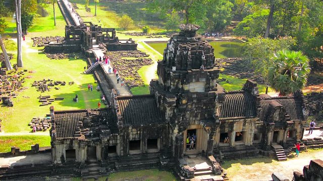 Video 1080p FullHD - Tourists strolling about, climbing steps and photographing ruins at Angkor Wat Temple in Cambodia. Timelapse shot from an elevated angle.