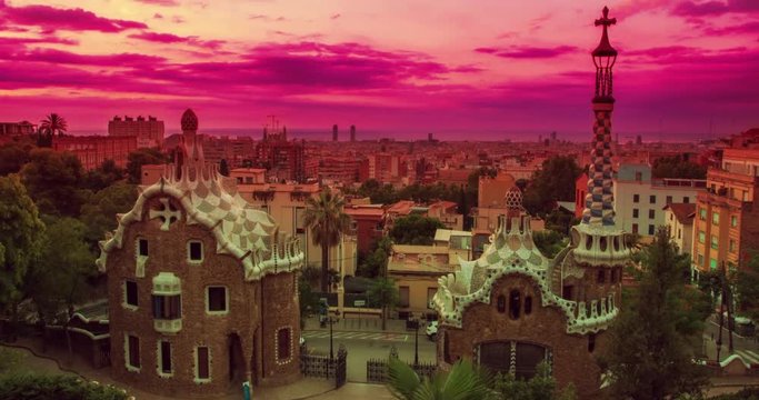 Barcelona landmarks. City view at sunrise. Timelapse of sunrise sky over Park Guell designed by Antoni Gaudi in Barcelona. Time lapse clouds over Barcelona city. Travel landmarks in Barcelona