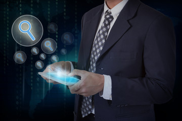 Businessman hand touch search icons on a tablet