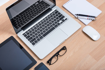 Top view open laptop with digital tablet and white smartphone