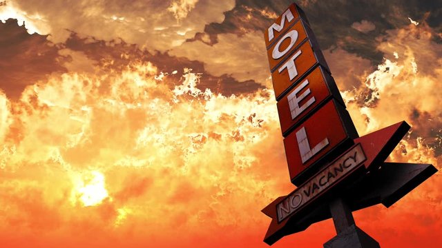 Old Grungy Motel Sign On the Road in a Wonderful Sunset 