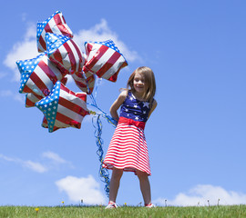 Cheerful American  girl holding balloons outside. 4th of July. Independence day. 