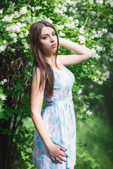 Fototapeta premium Beautiful woman in a cute dress on nature