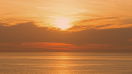 Perspectives of beautiful sunset above the sea. Orange sky at summer.