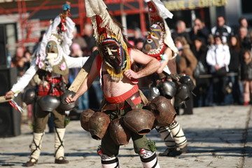 Pernik, Bulgaria - January 14, 2008: Unidentified man in traditional Kukeri costume are seen at the Festival of the Masquerade Games Surva in Pernik, Bulgaria.