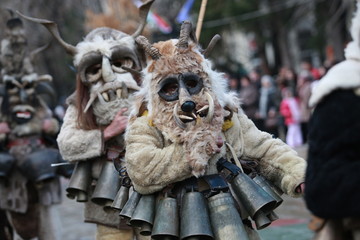 Pernik, Bulgaria - January 14, 2008: Unidentified man in traditional Kukeri costume are seen at the Festival of the Masquerade Games Surva in Pernik, Bulgaria.