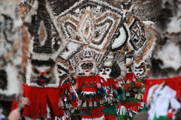 Pernik, Bulgaria - January 14, 2008: Unidentified man in traditional Kukeri costume are seen at the Festival of the Masquerade Games Surva in Pernik, Bulgaria.
