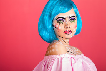 Photo of young woman with professional comic pop art make up. Creative beauty style.