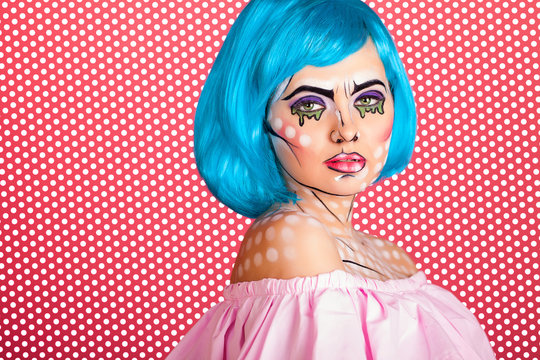 Photo of young woman with professional comic pop art make up. Creative beauty style.