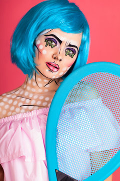 Photo of young woman with professional comic pop art make up. Creative beauty style.