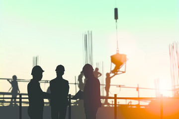 Silhouette engineer standing orders for construction crews to wo