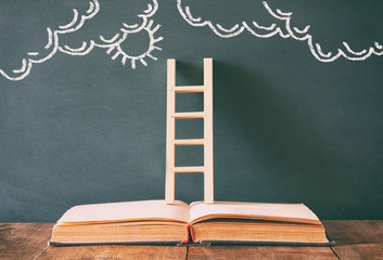 wooden ladder and cloud infographics on blackboard