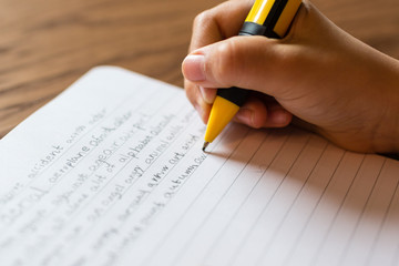 Girl writing by hand on notepad