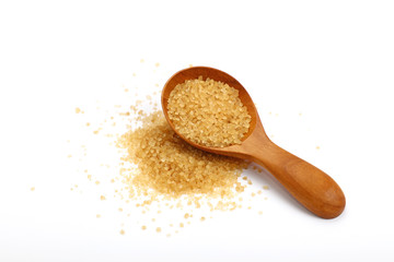 Scoop of brown cane sugar isolated on white