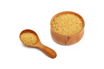 Scoop and bowl of brown cane sugar on white