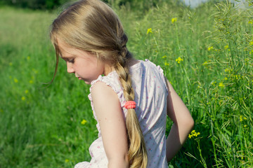 Little girl walks in the field  