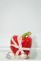 Red sweet pepper with measuring tape. Healthy eating. Healthy lifestyle. Diet. Source of vitamins....