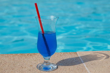 blue cocktail near pool