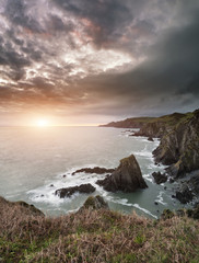 Dramatic stormy sunrise landscape over Bull Point in Devon Engla
