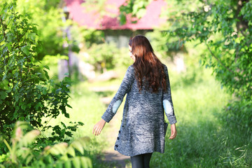 Young beautiful girl walking in park