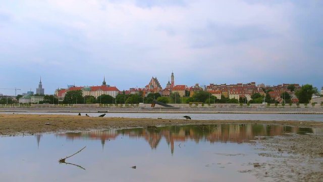 View on Warsaw Old Town from Visla river with reflection in Poland